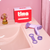 The tampon insertion aid sits on the side of a pink sink in front of a TINA-branded box.