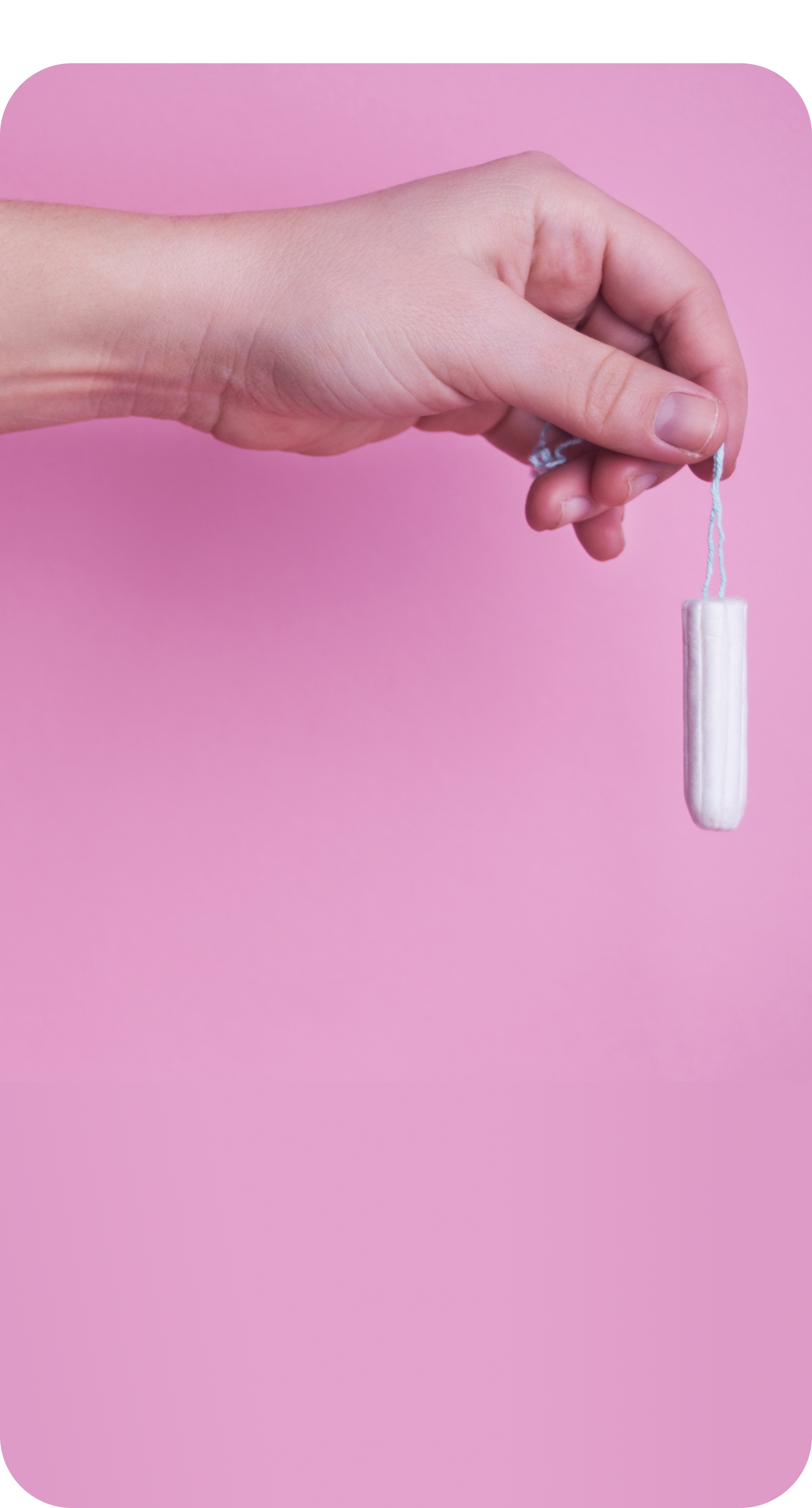Hand holding a tampon against a pink background.