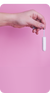Hand holding a tampon against a pink background.